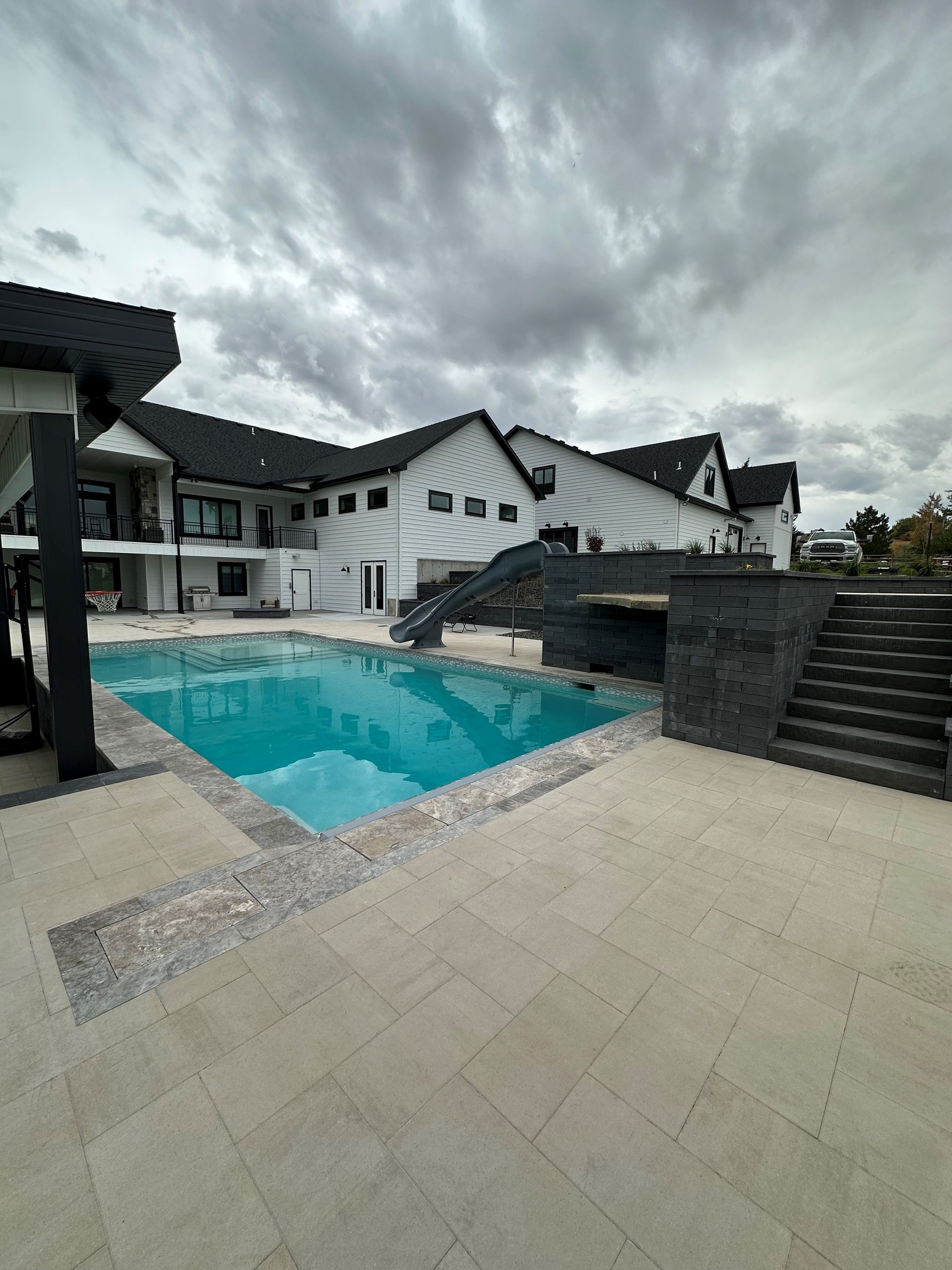 A large house with a large swimming pool in front of it.