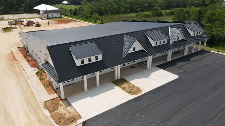 An aerial view of a large building with a black roof