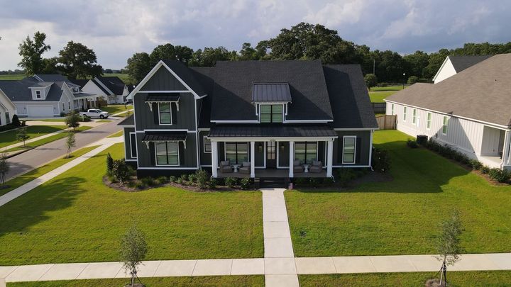 An aerial view of a house in a residential neighborhood.