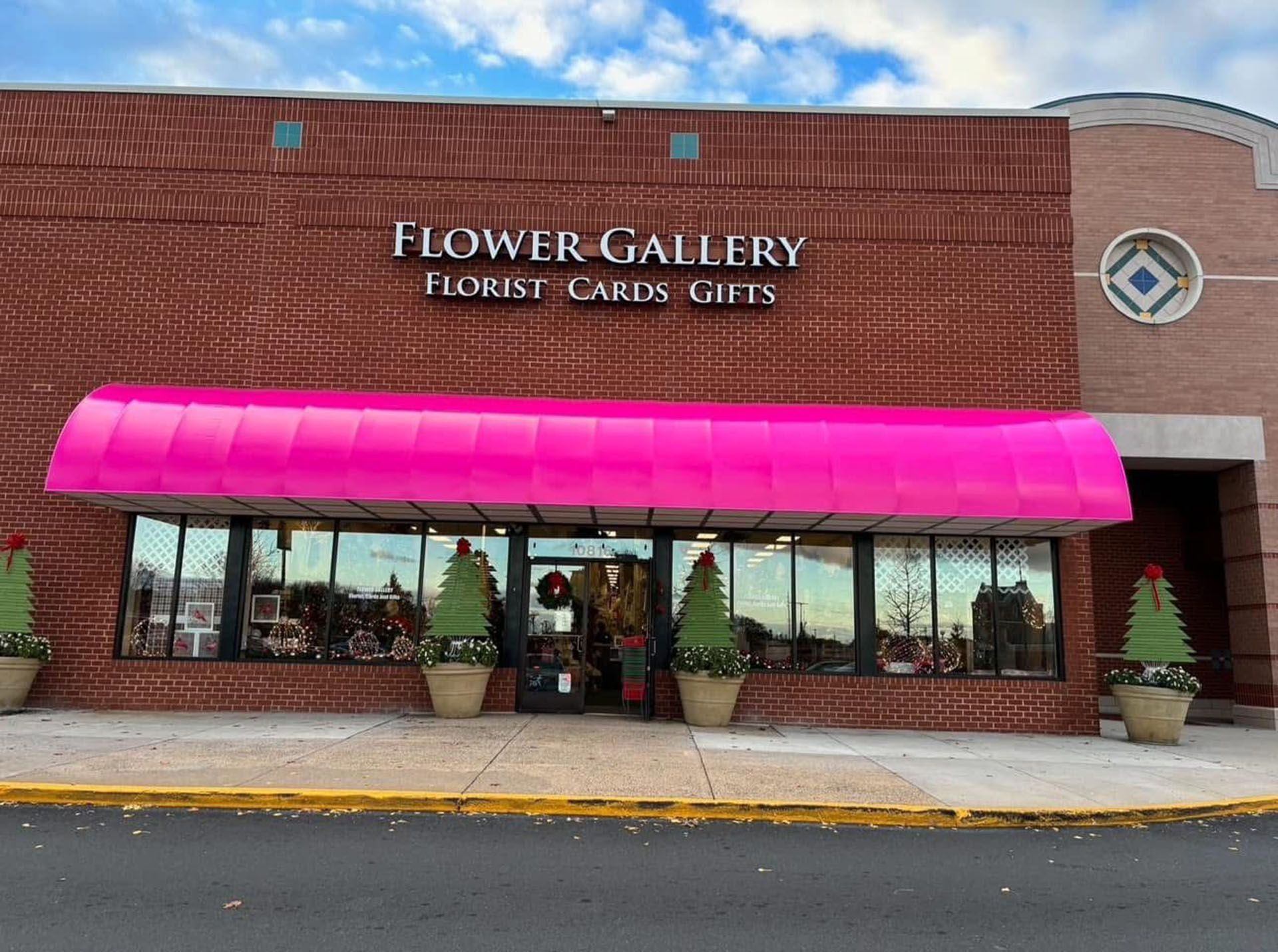 Flower Gallery storefront with bright pink awning and flower displays