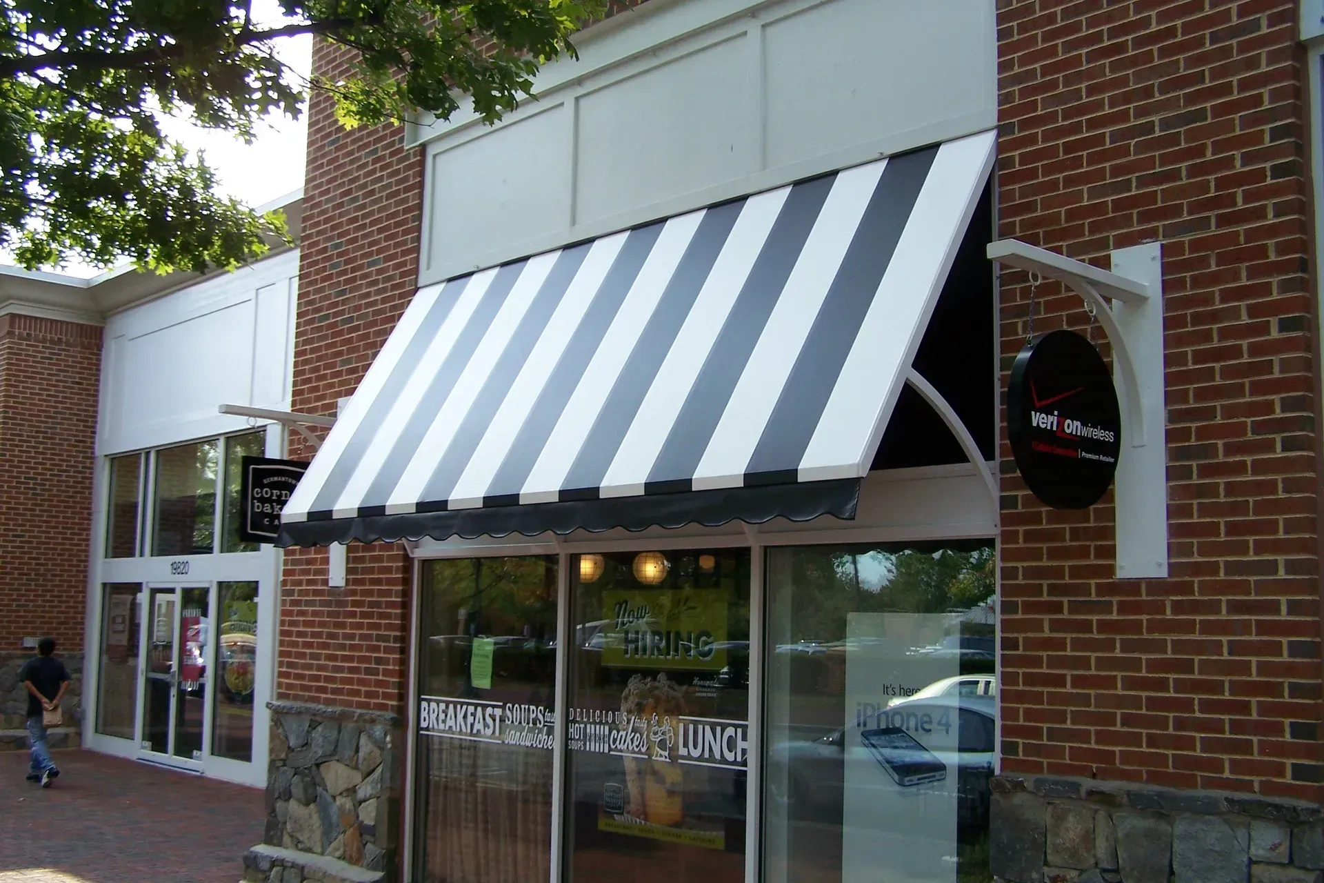 Storefront with black-and-white striped awning on a brick building