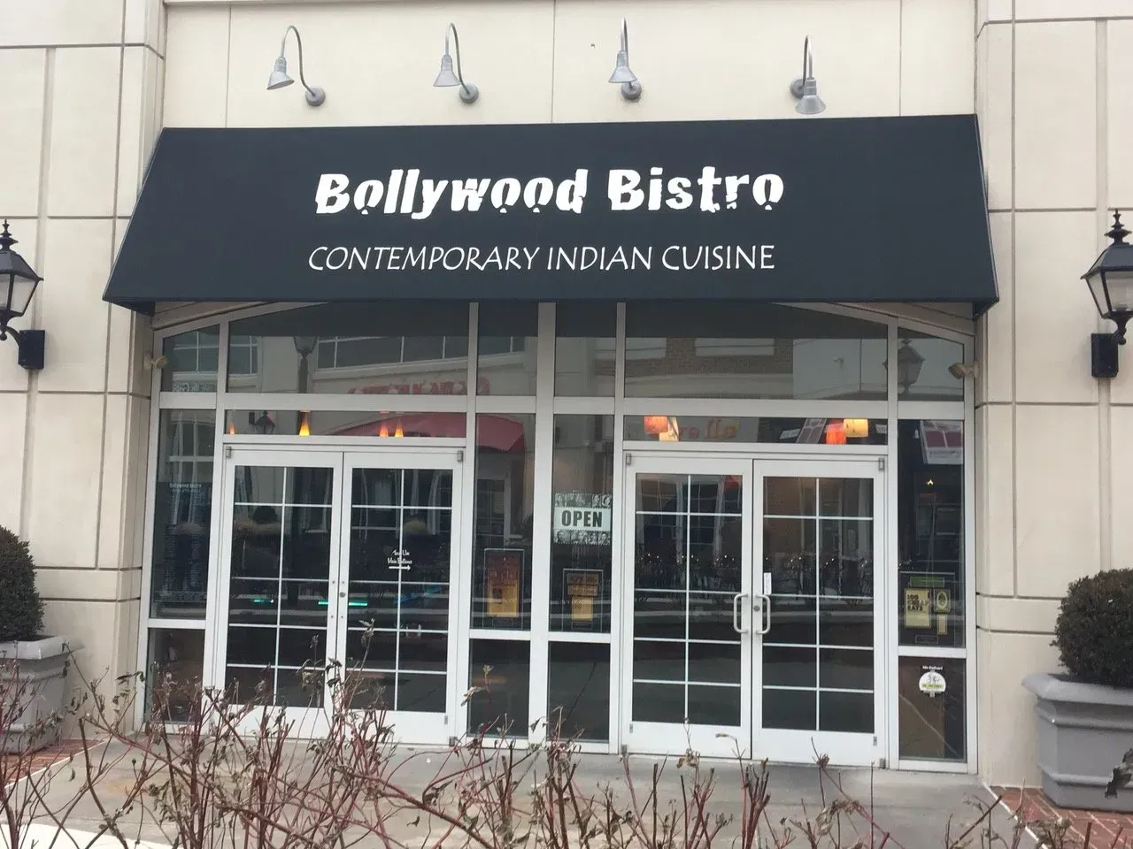 Bollywood Bistro storefront with black awning and glass entrance, serving contemporary Indian cuisine