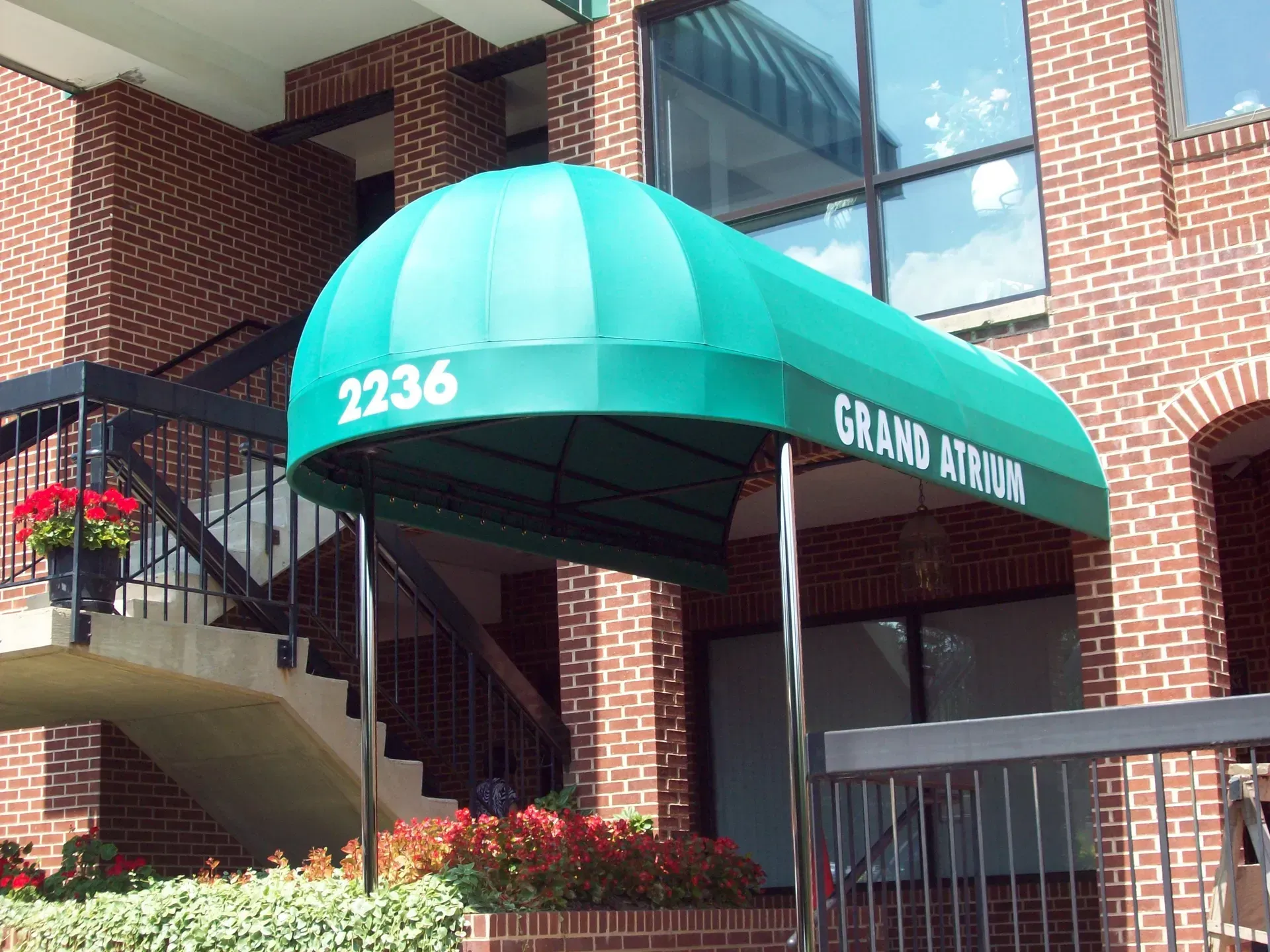 Brick apartment entrance with green awning labeled 2236 and Graham Street.