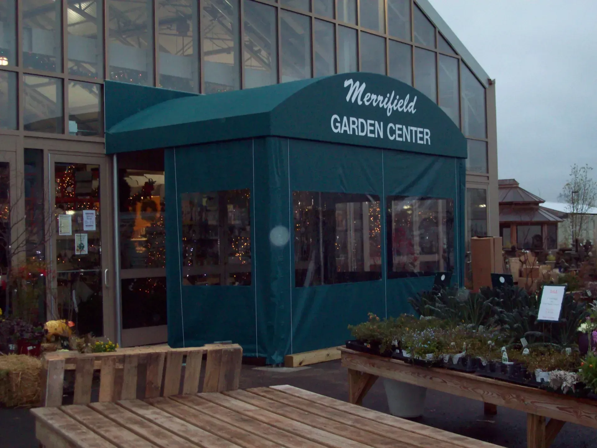 Merryfield Garden Center storefront with teal awning and plant displays outside