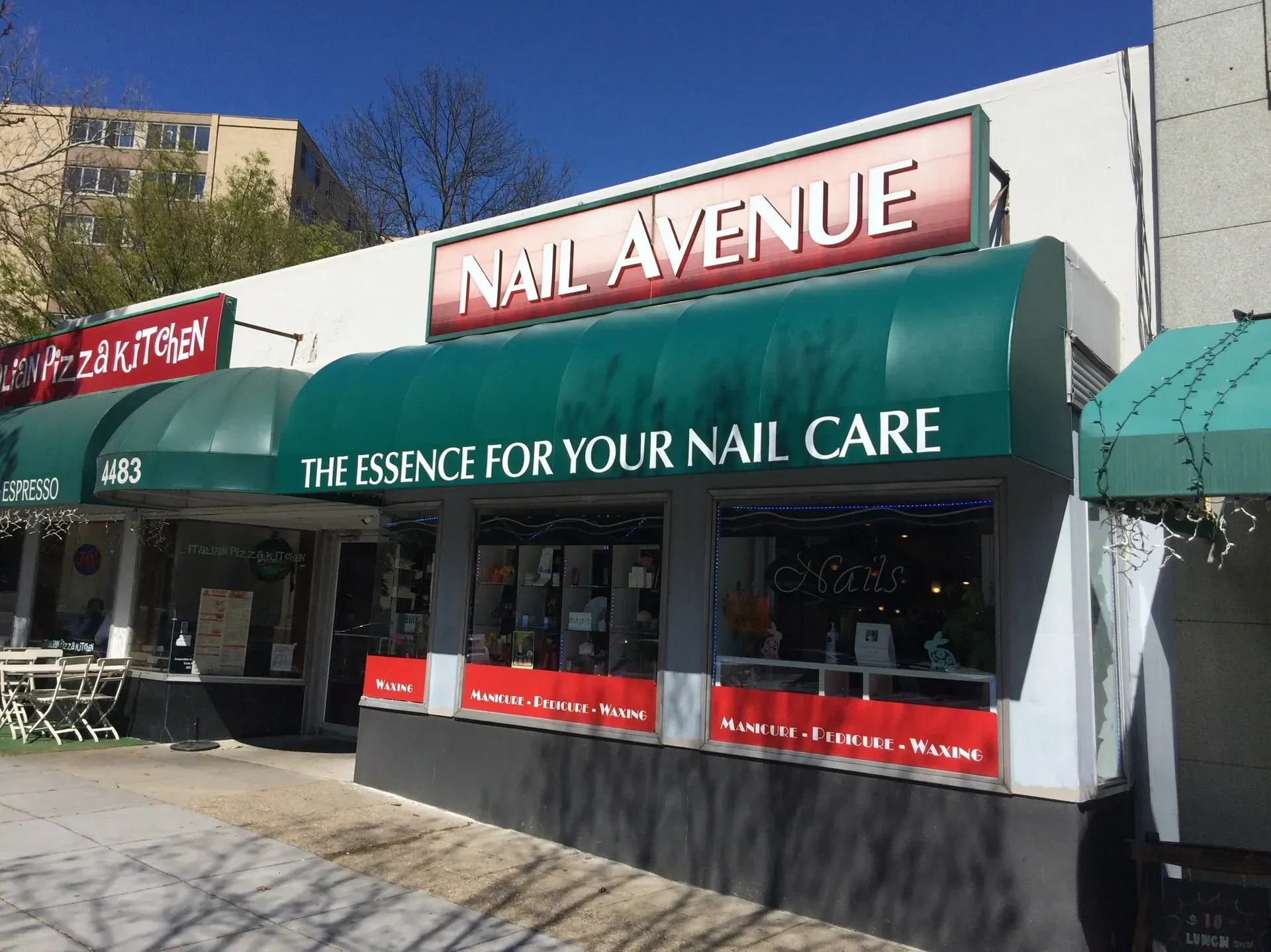 Nail Avenue storefront with green awnings and “The essence for your nail care” sign