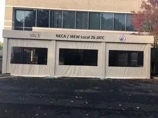 NECA/IBEW Local 26 JATC building exterior with beige facade and dark windows