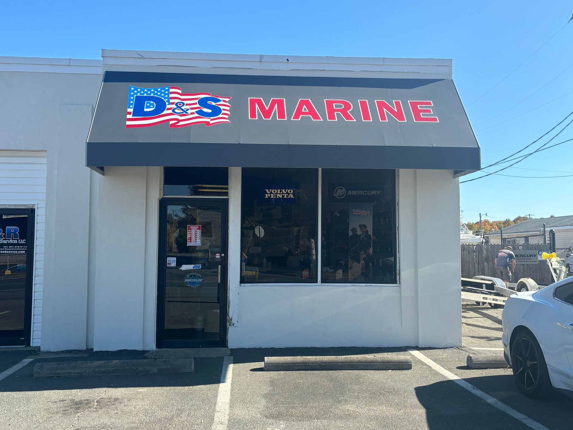 D&S Marine building with a gray awning and American flag logo, seen from the street.