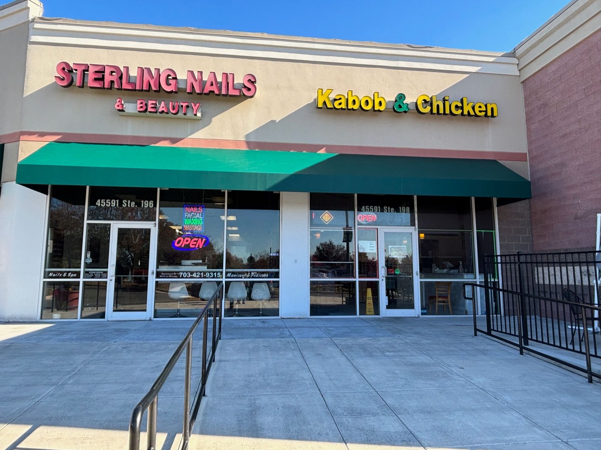 Storefront with signs for Sterling Nails & Beauty and Kabob & Chicken under a green awning.