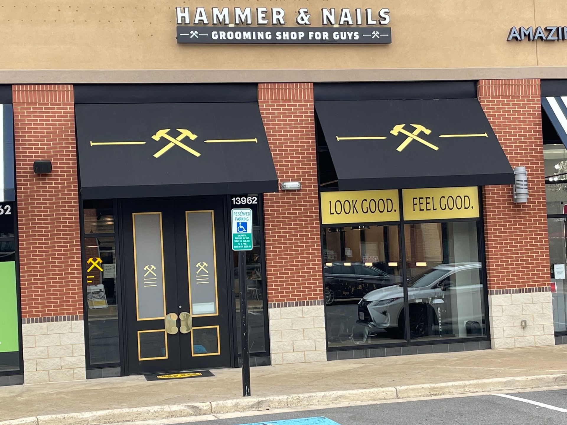 Hammer & Nails grooming shop storefront with black awnings and brick facade.