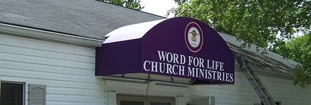 Purple awning over church entrance reading “Word for Life Church Ministry”
