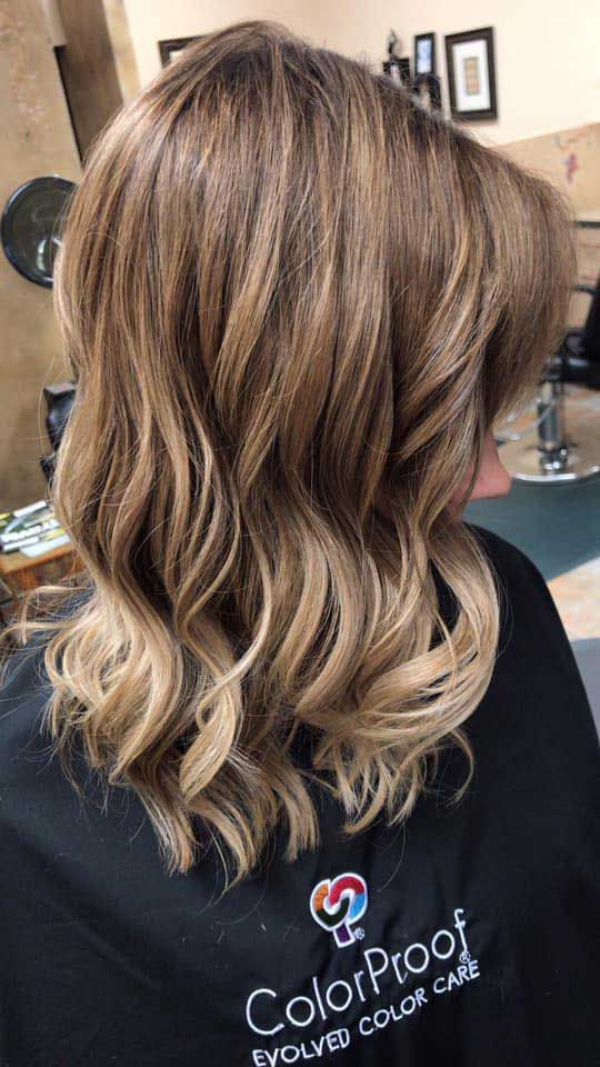 A woman is getting her hair done in a salon.
