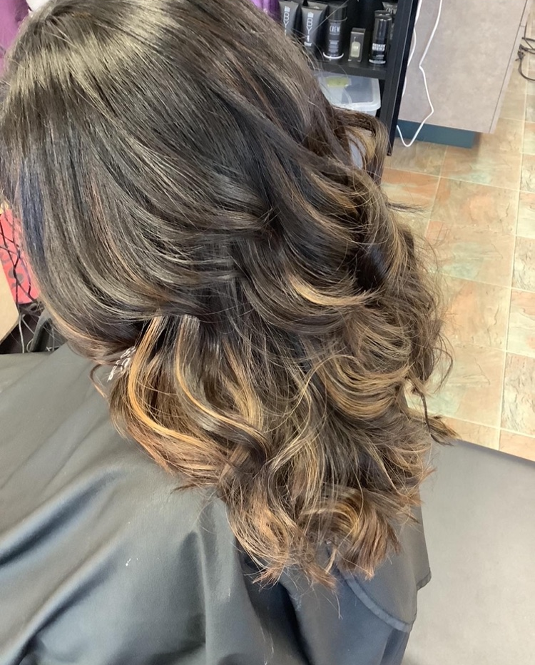 A woman is getting her hair done in a salon.