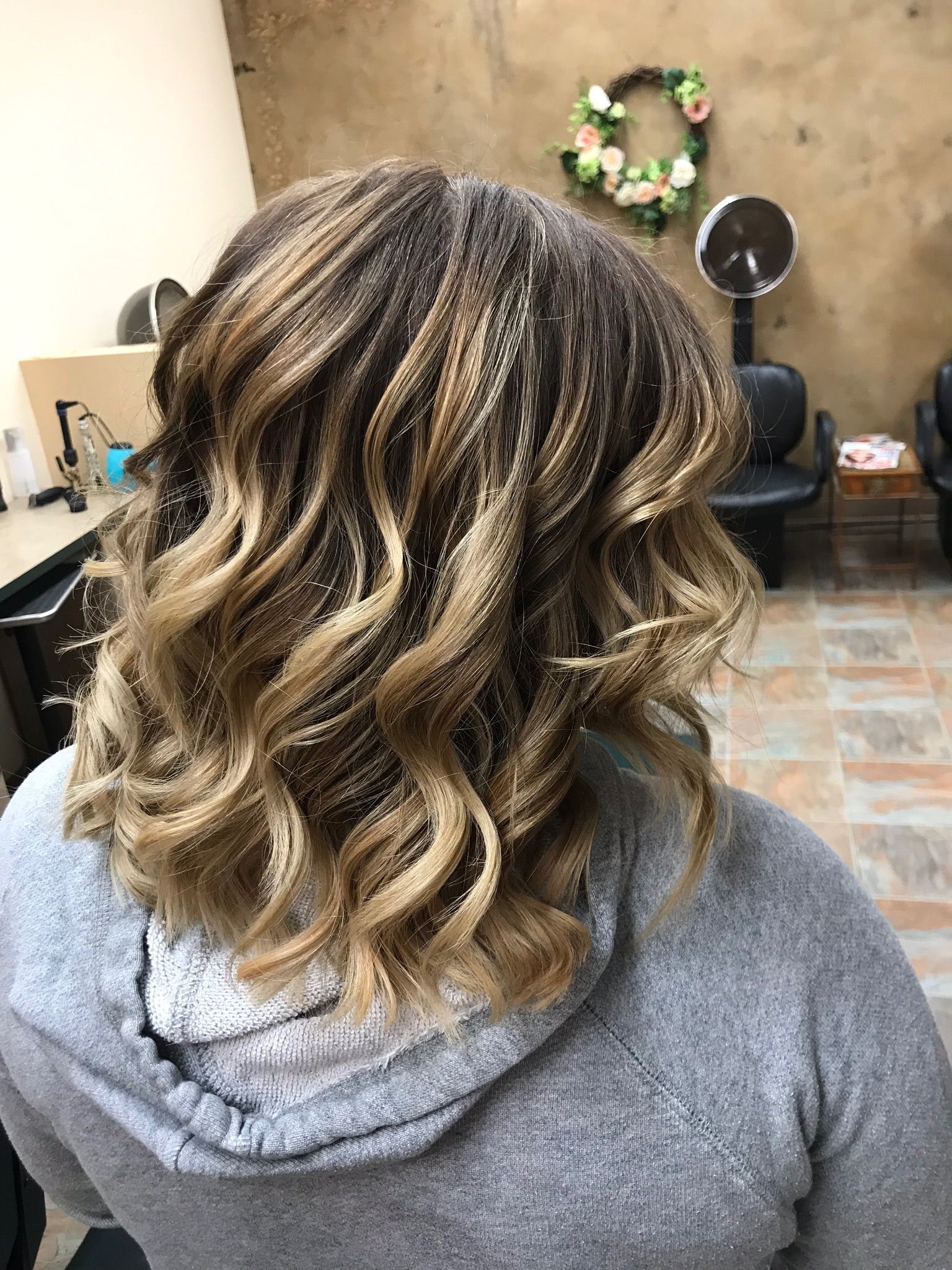 A woman is getting her hair done in a salon.