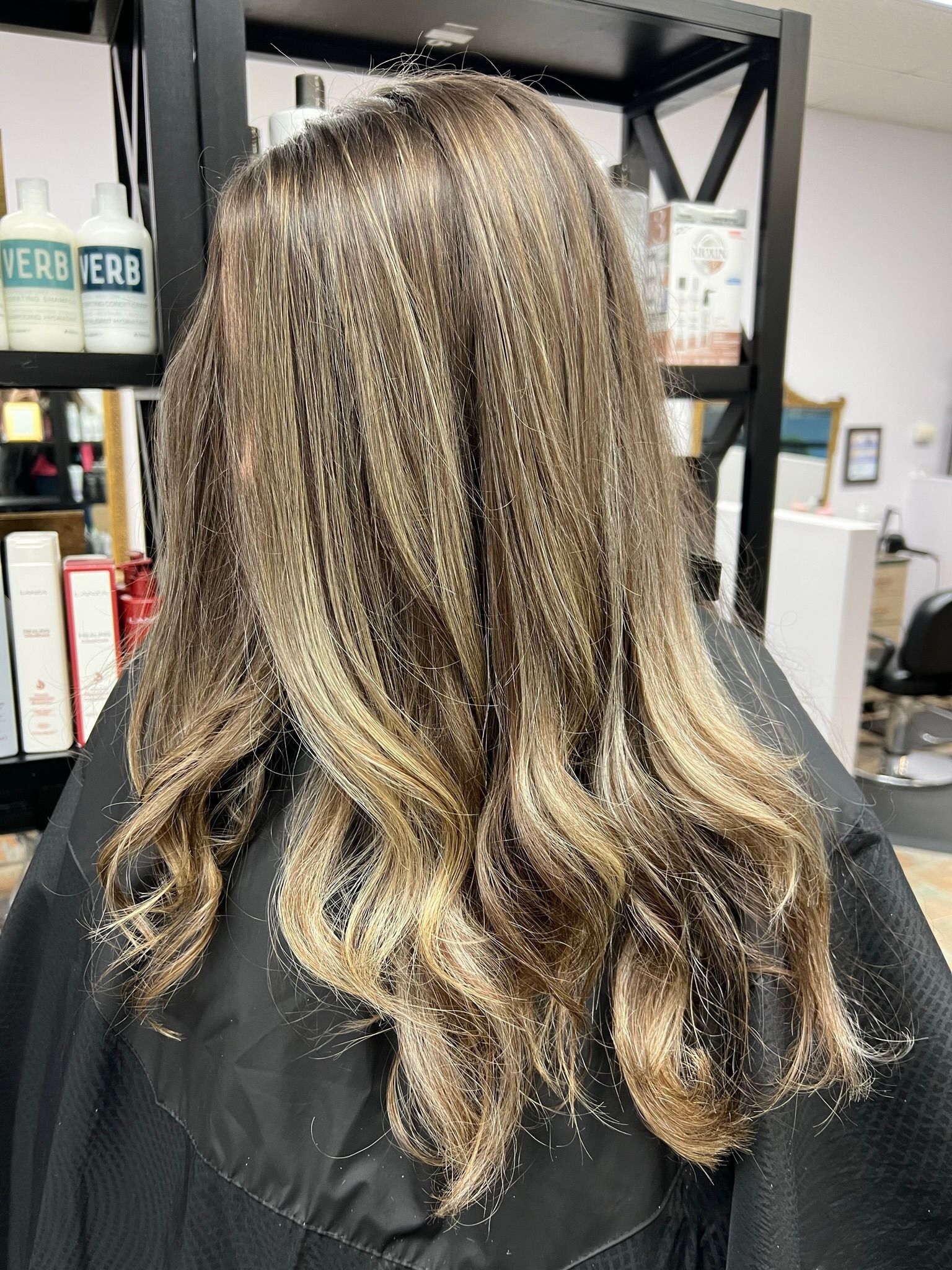 A woman is getting her hair done in a salon.