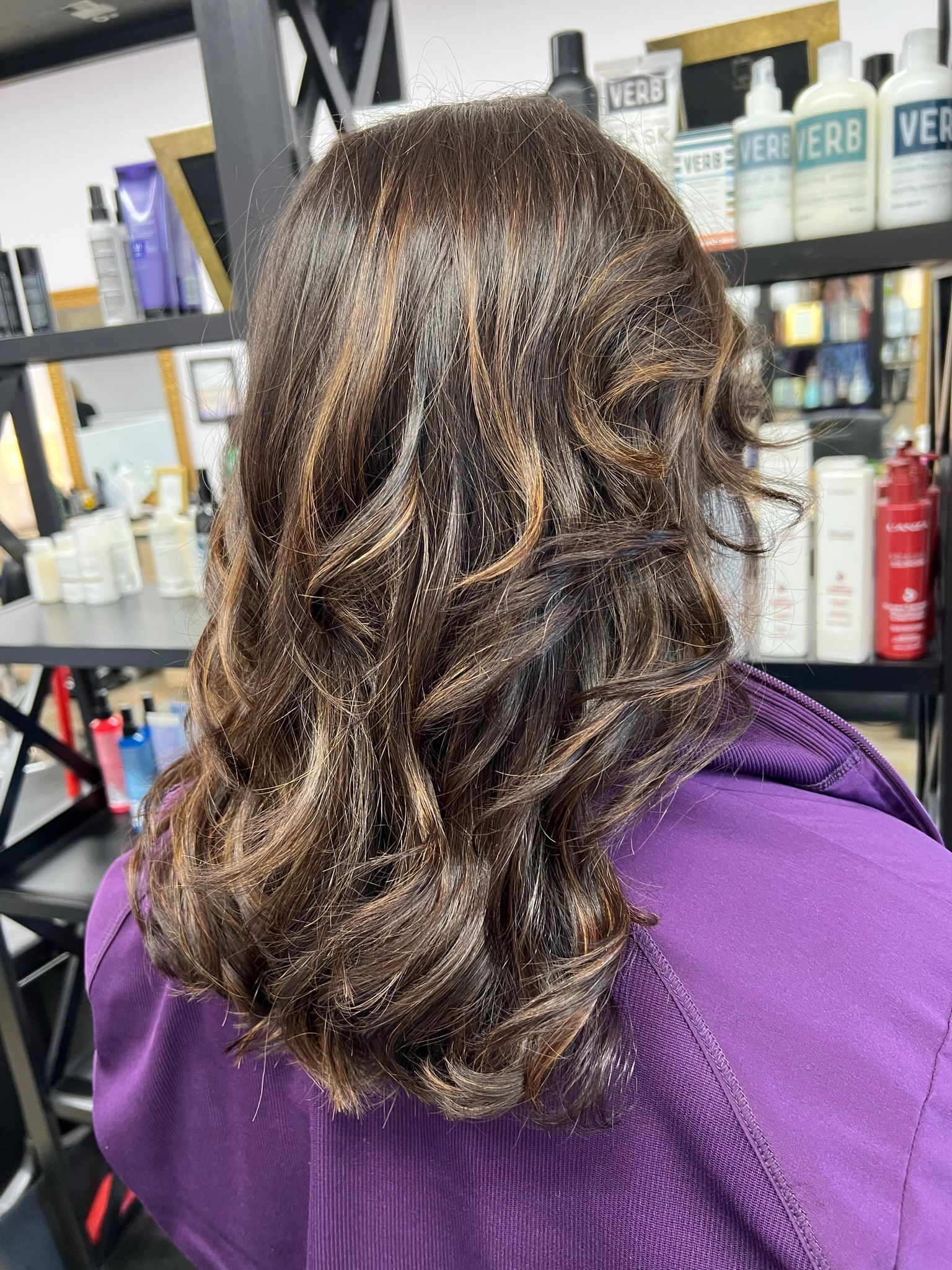 A woman is getting her hair done in a salon.