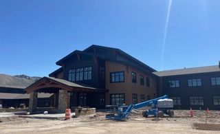 An aerial view of a house with a black roof