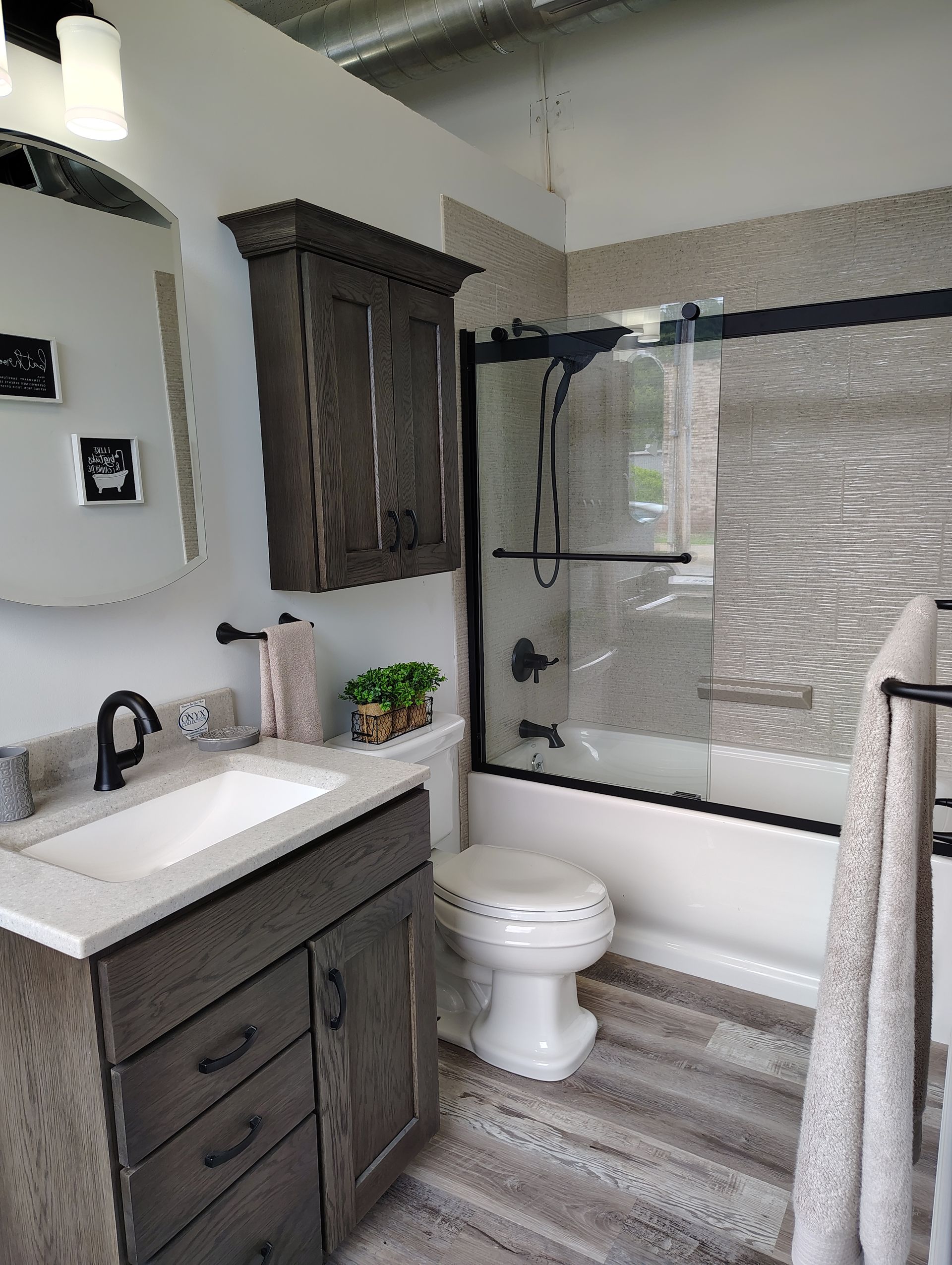 A bathroom with a sink, toilet, bathtub, and mirror