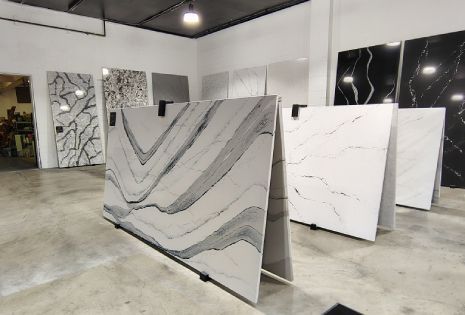 A showroom filled with lots of different types of granite slabs