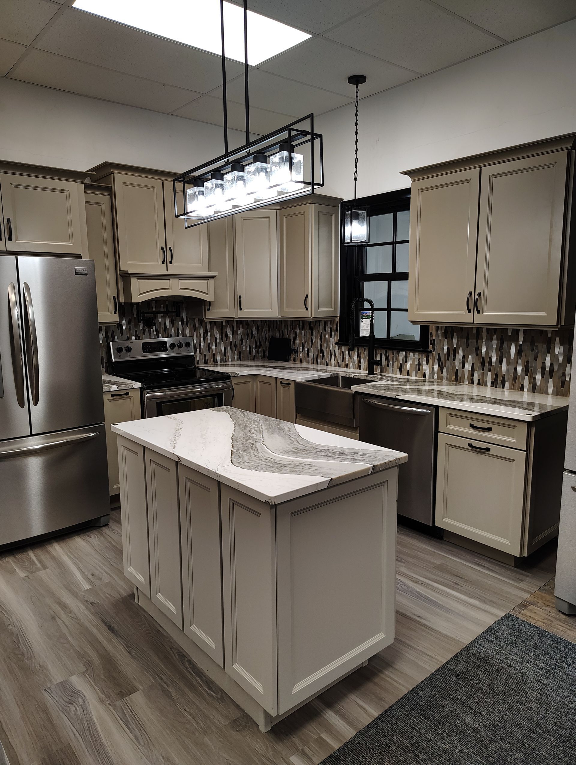 A kitchen with stainless steel appliances and a large island in the middle