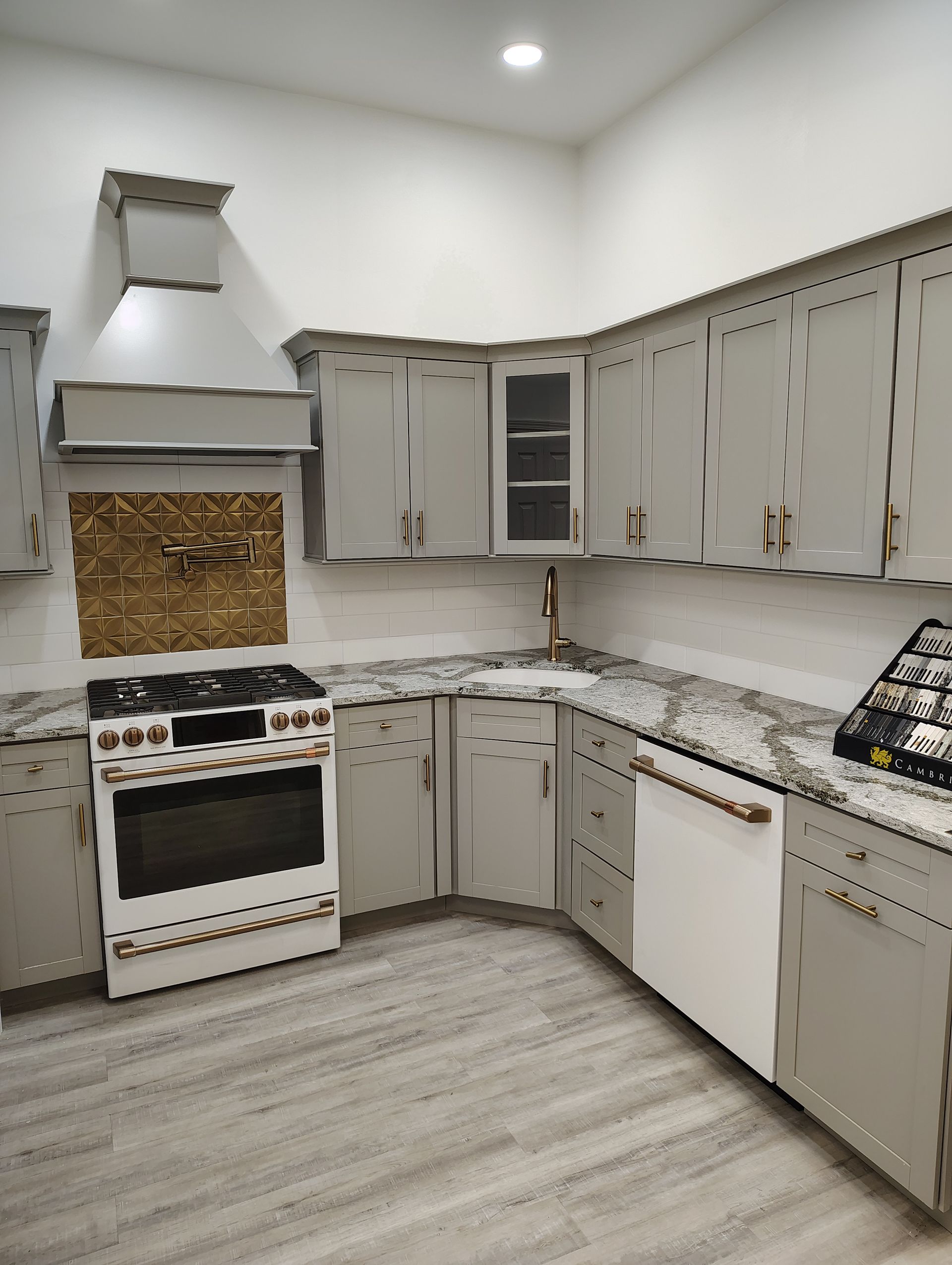 A kitchen with gray cabinets and a white stove