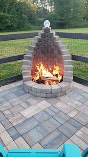 There is a fire pit in the middle of the patio.