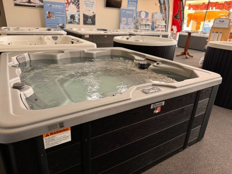 A row of hot tubs are lined up in a store.