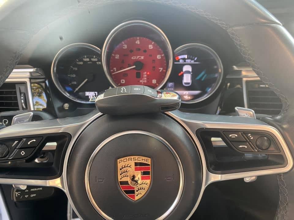 Porsche steering wheel and dashboard with red center gauge and digital display