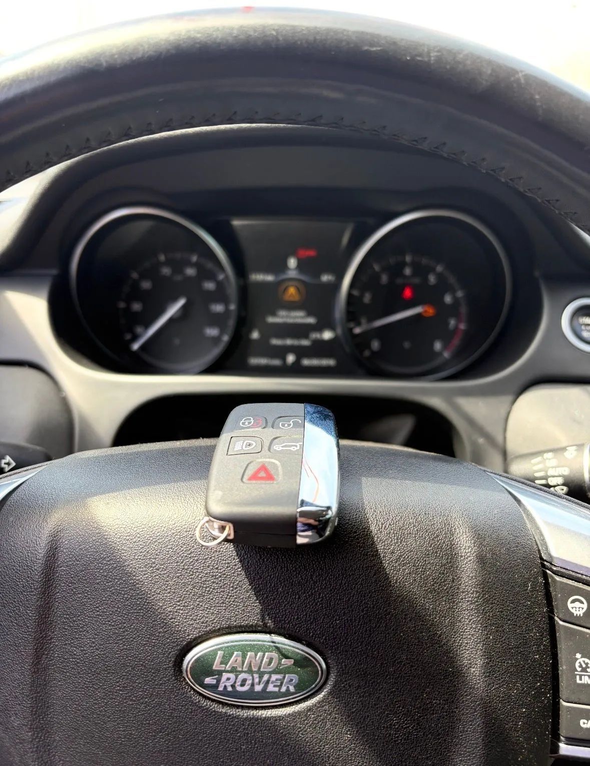 Land Rover steering wheel and instrument cluster viewed from the driver’s seat