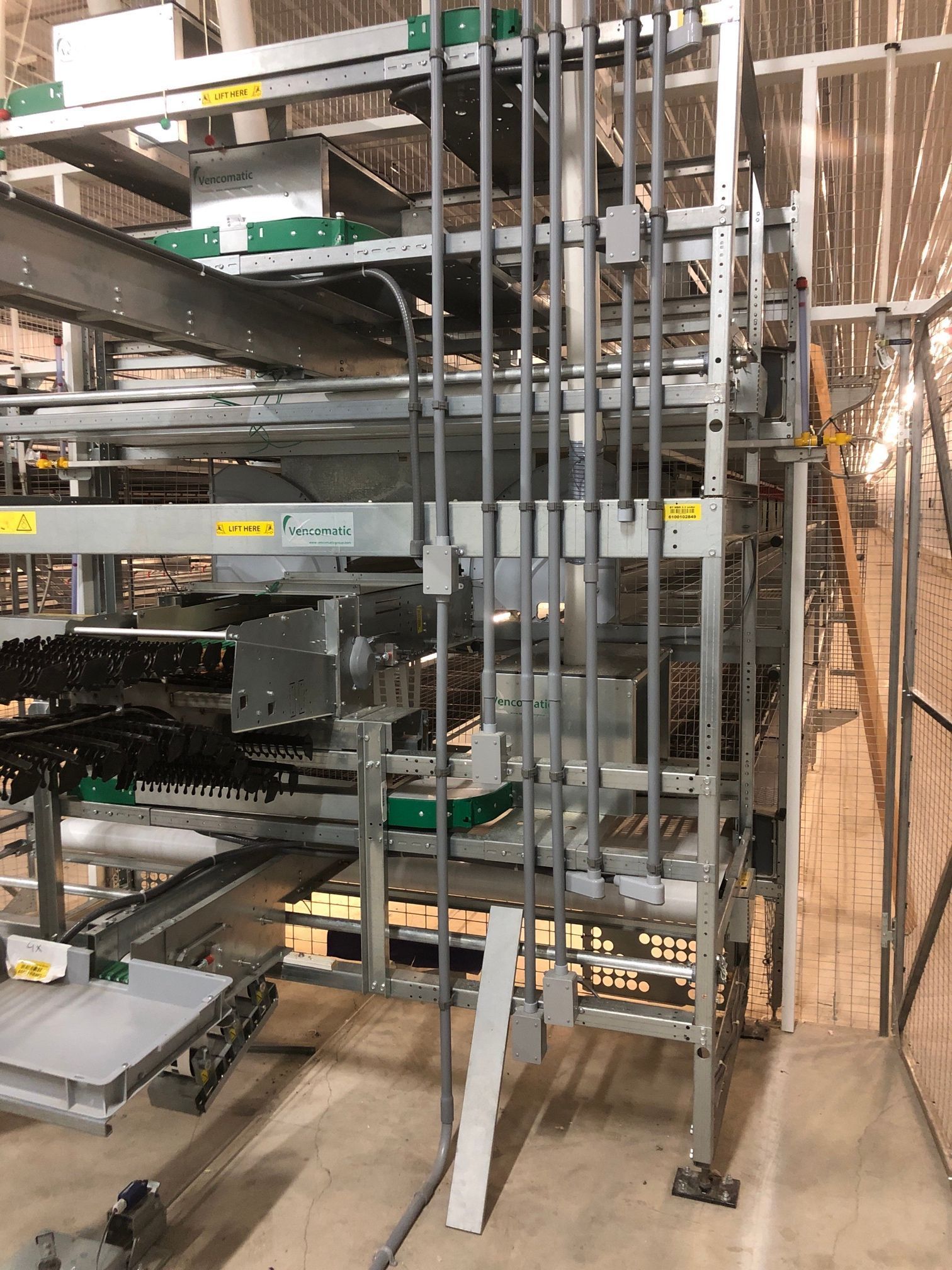 Metal framework with electrical conduit running vertically; industrial setting.