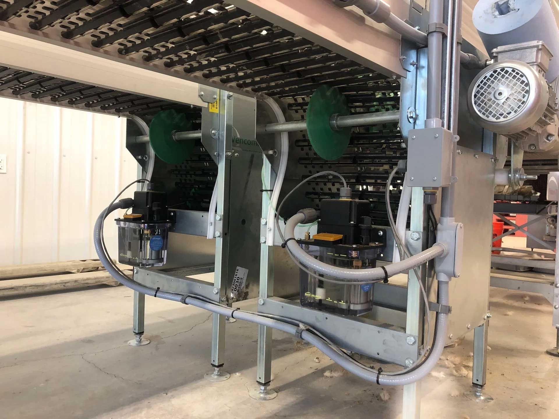 Industrial egg collection system with rollers, motors, and conveyor components.