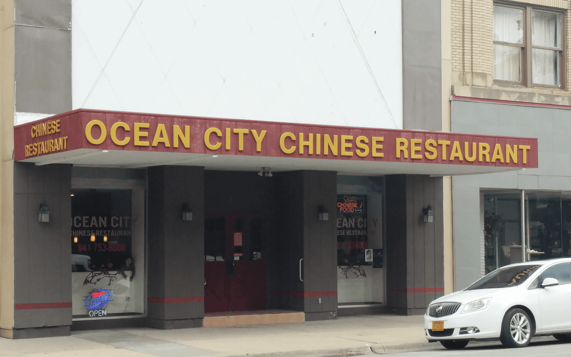 A brick building with a sign that says ag land realty