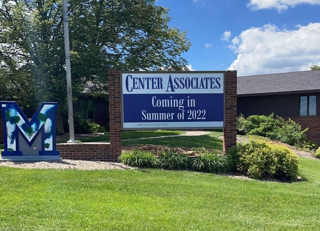 A sign that says center associates coming in summer of 2022