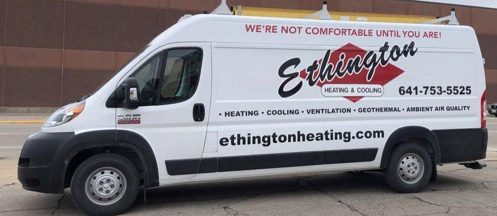 A white van is parked on the side of the road.