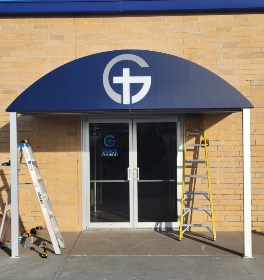 A church with a blue awning over the door