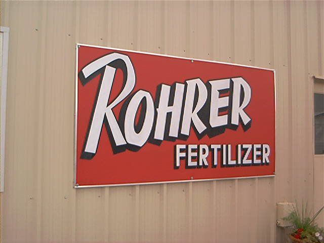 A sign on the side of a building that says rohrer fertilizer