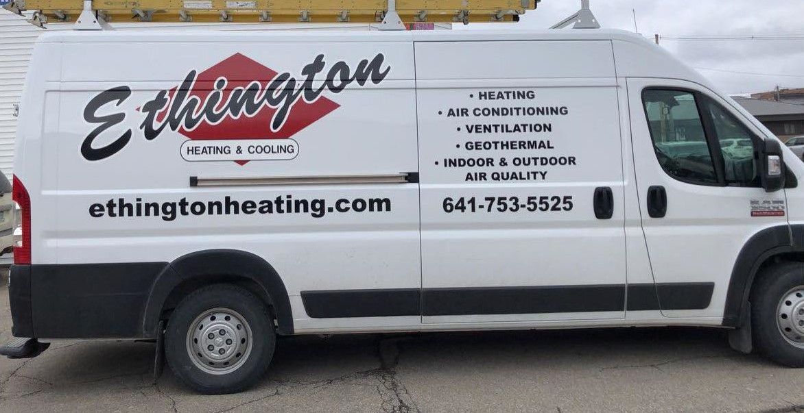 A white van is parked on the side of the road.