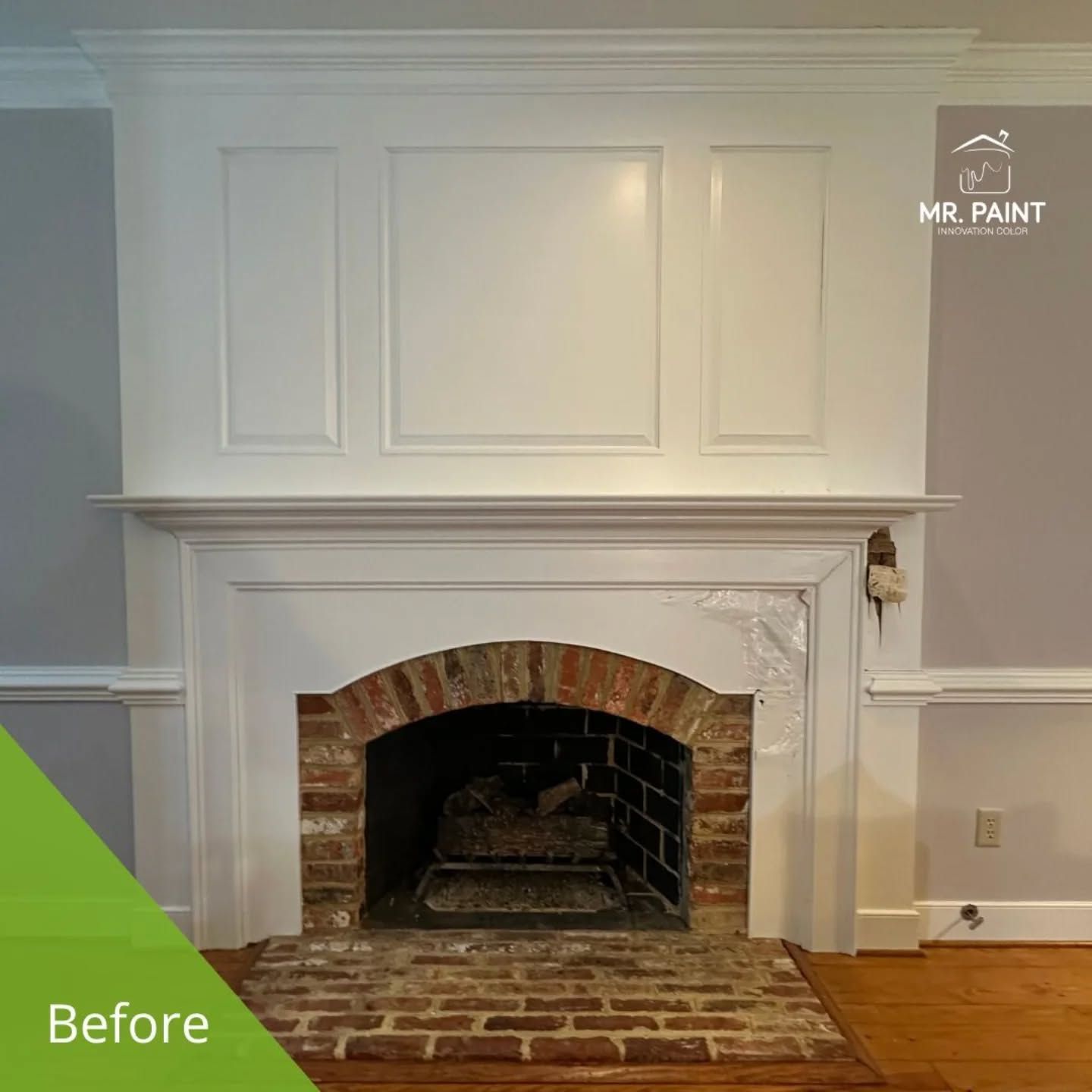 White-painted fireplace with brick interior and gray walls; 