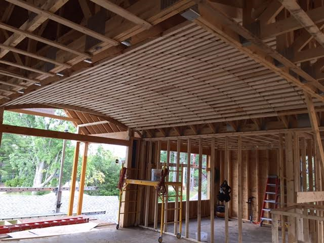 The Diamond Room sign hangs outside a building with tall columns. The sign is black with white text.