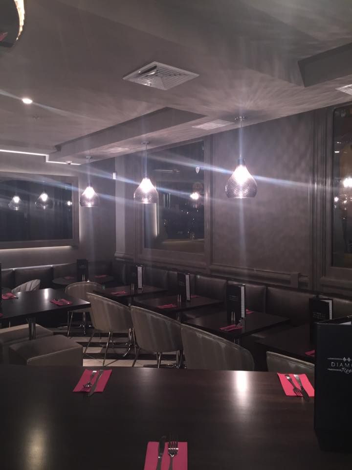 Two-story house under construction, with wood framing, sheathing, and protective wrap. Scaffolding is in place.