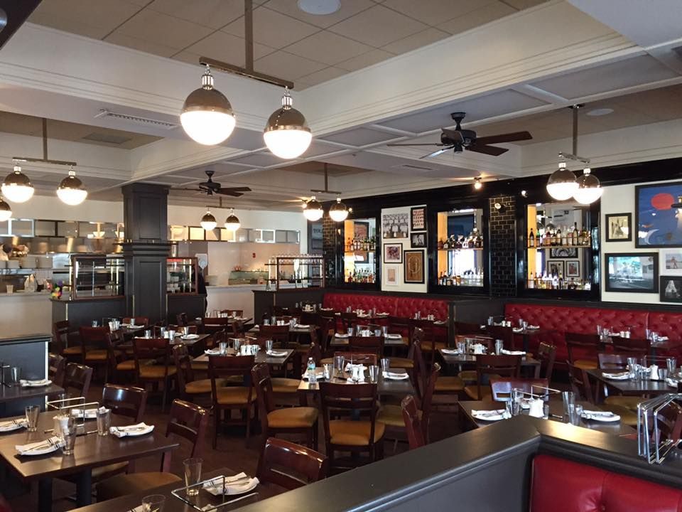 Interior of a liquor store with shelves of bottles. Wood-paneled wall backdrop, wooden floor, and low-lit ceiling.