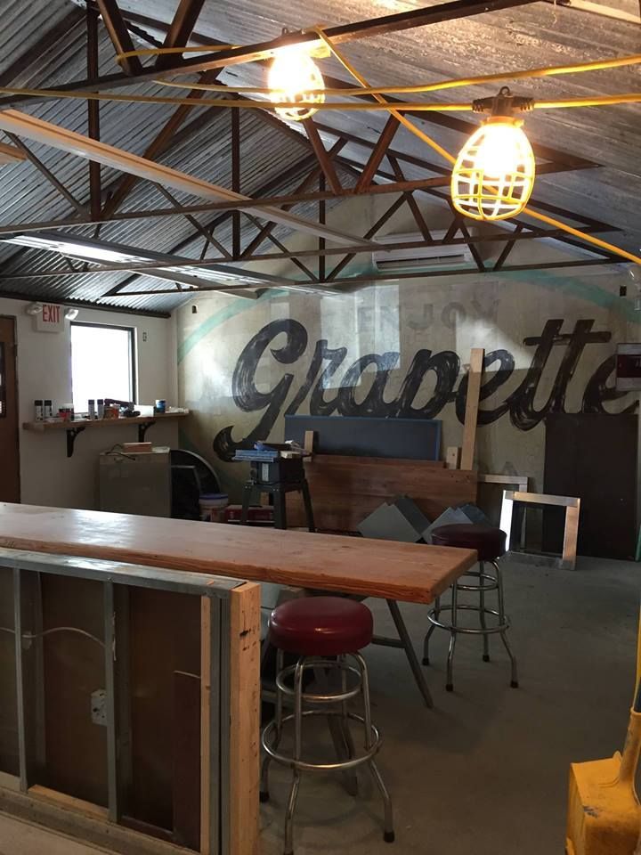 Apartment buildings under a cloudy sky. Green grass, trees, and walkways are visible in the foreground.