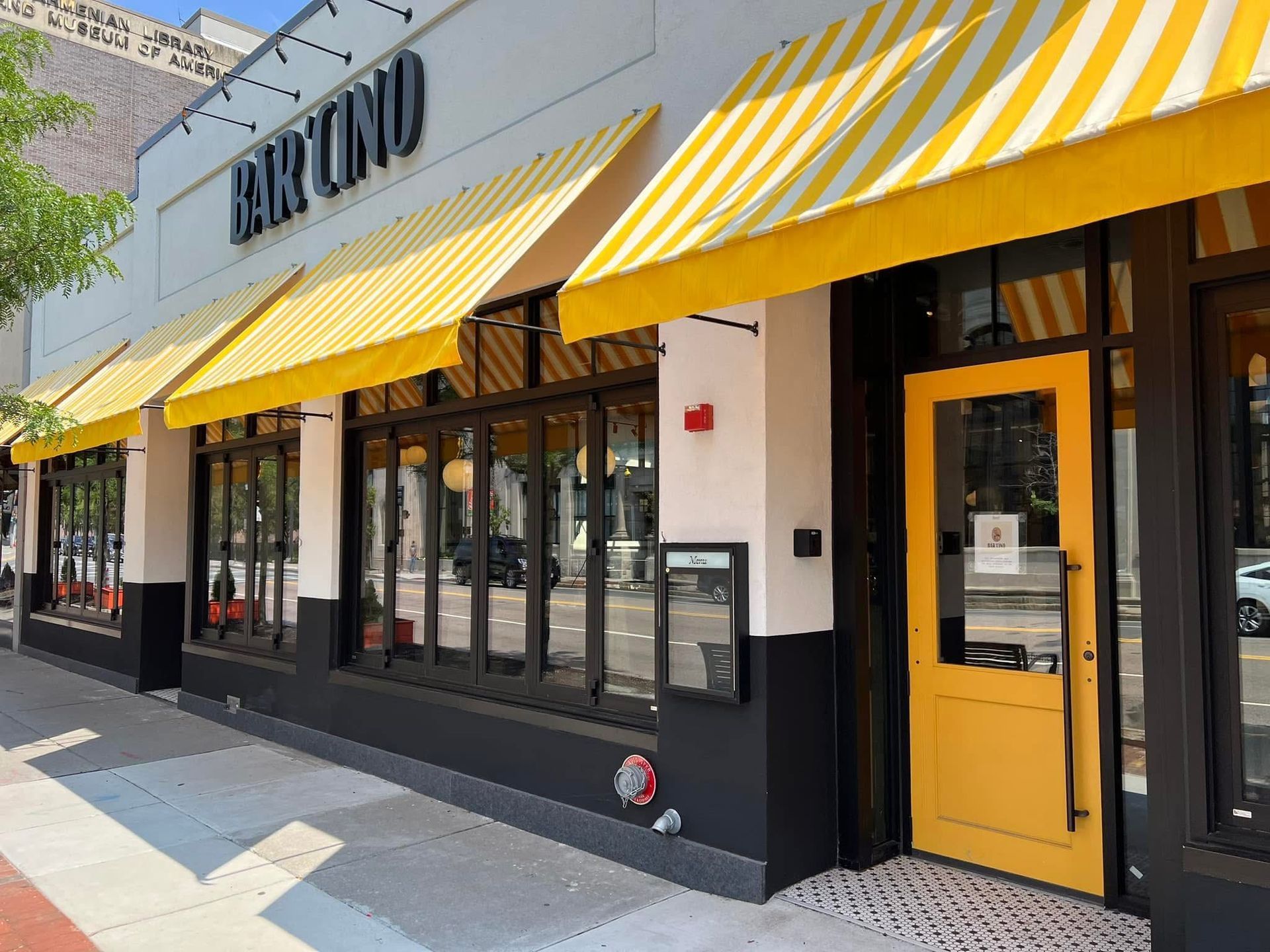 Restaurant Bar Cino with yellow awnings and door