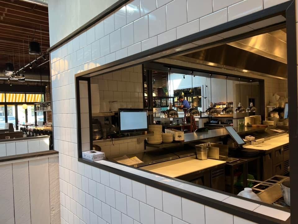 Interior view of a restaurant kitchen through a service window