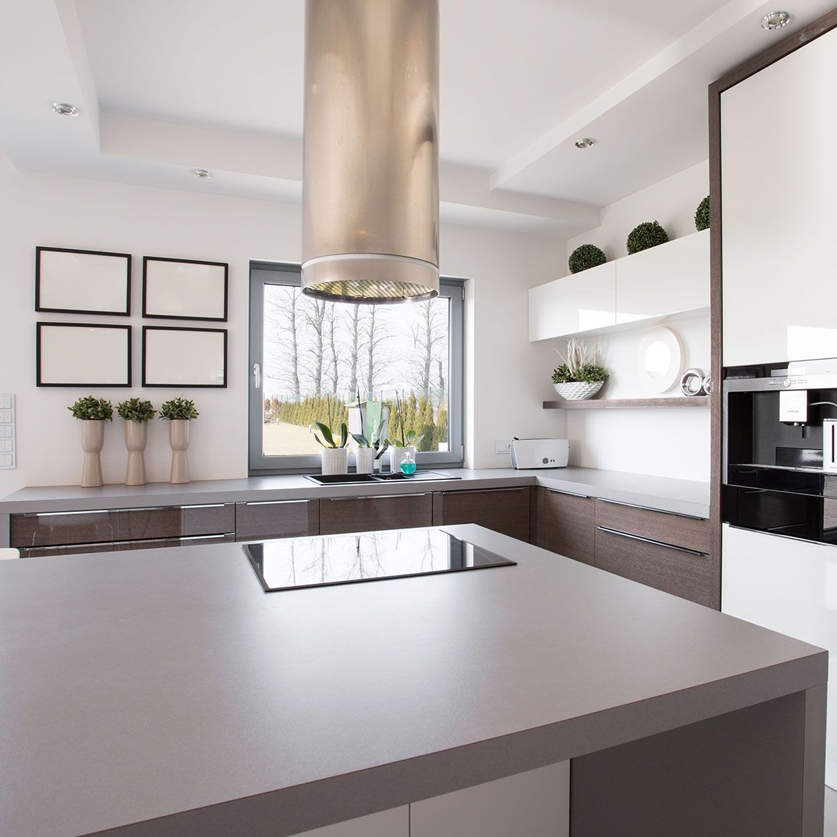 A kitchen with laminate countertops and a stove top oven