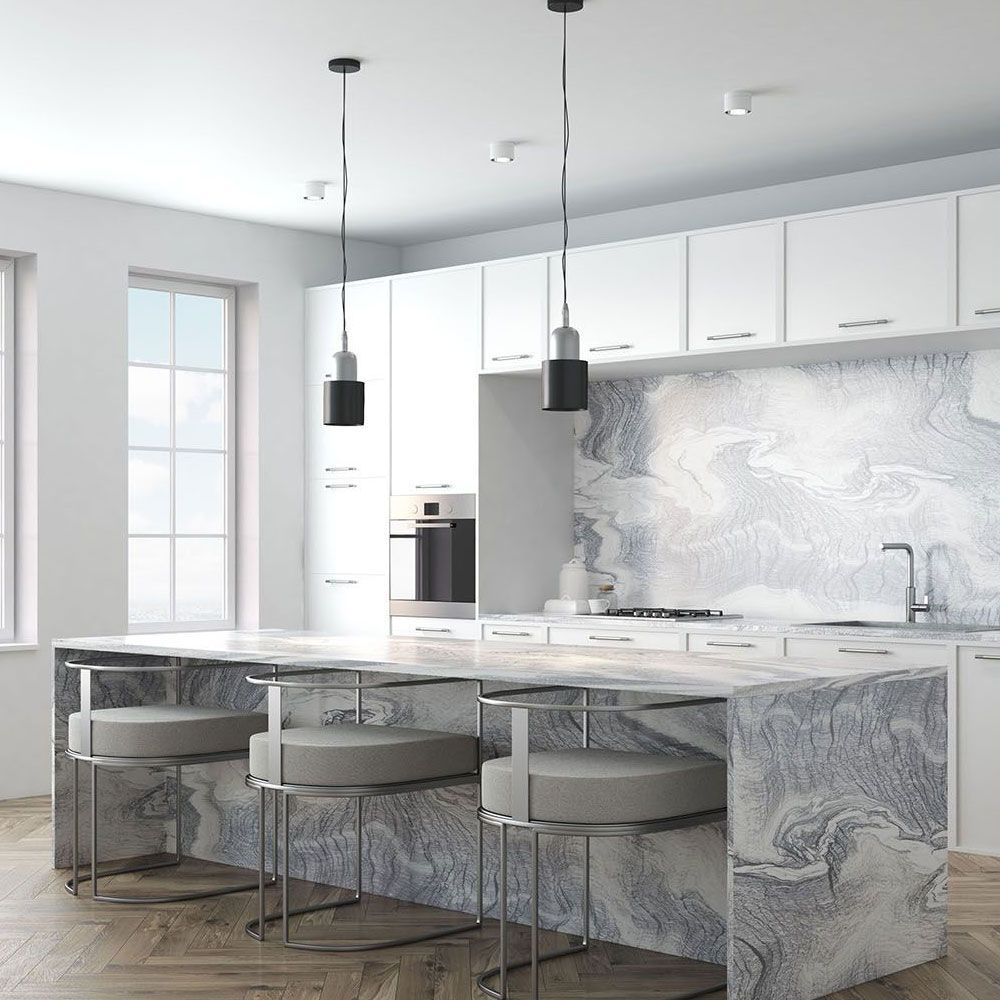 A kitchen with white cabinets and a laminate countertop