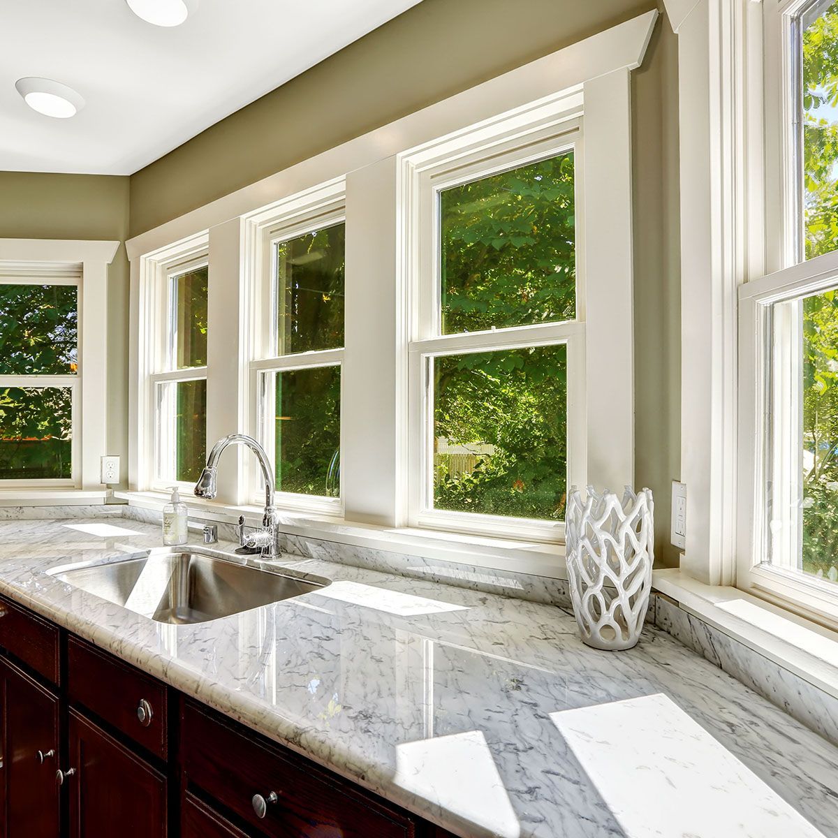 A kitchen with a neolith countertop and a sink