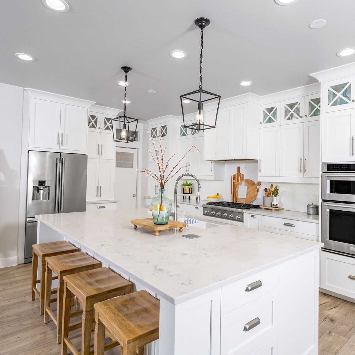 A kitchen with neolith countertops and wooden stools
