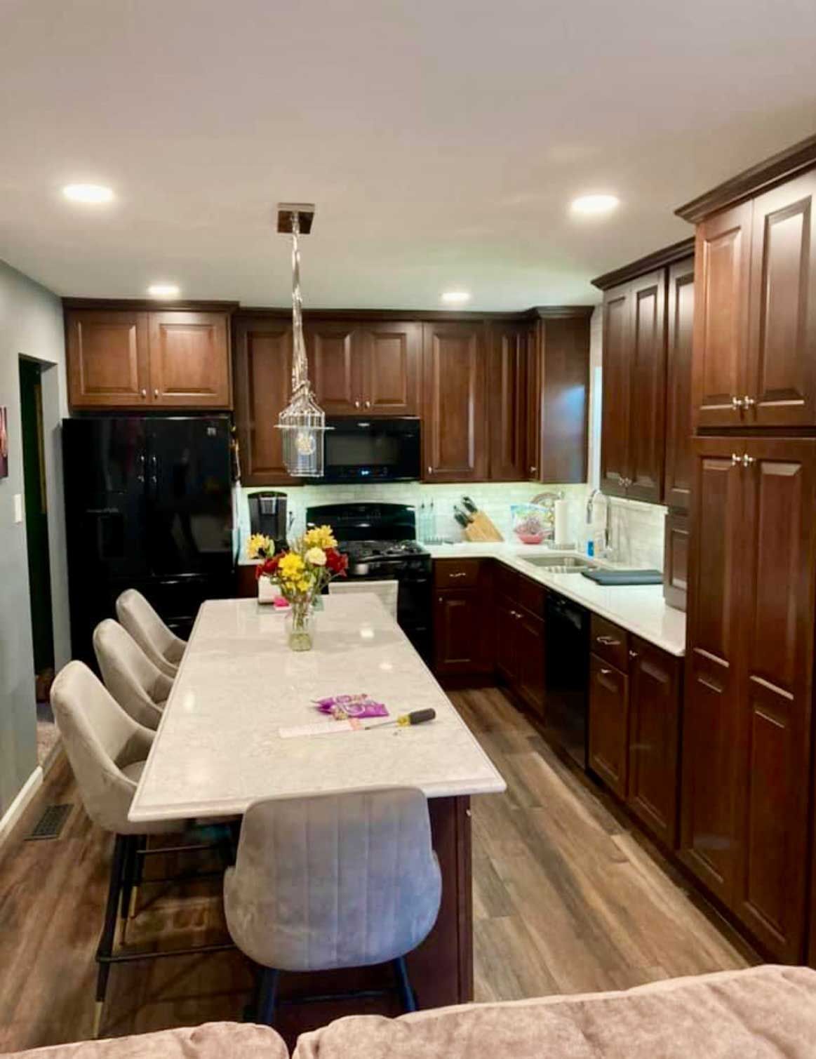 A kitchen with a table and chairs in it