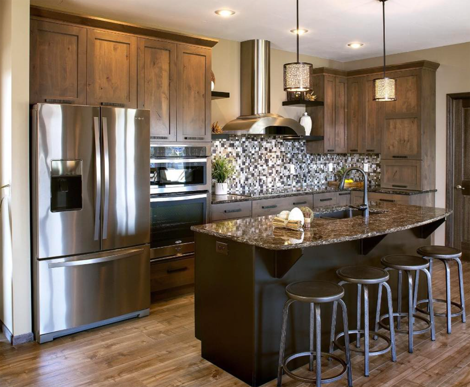 A kitchen with stainless steel appliances and wooden cabinets.