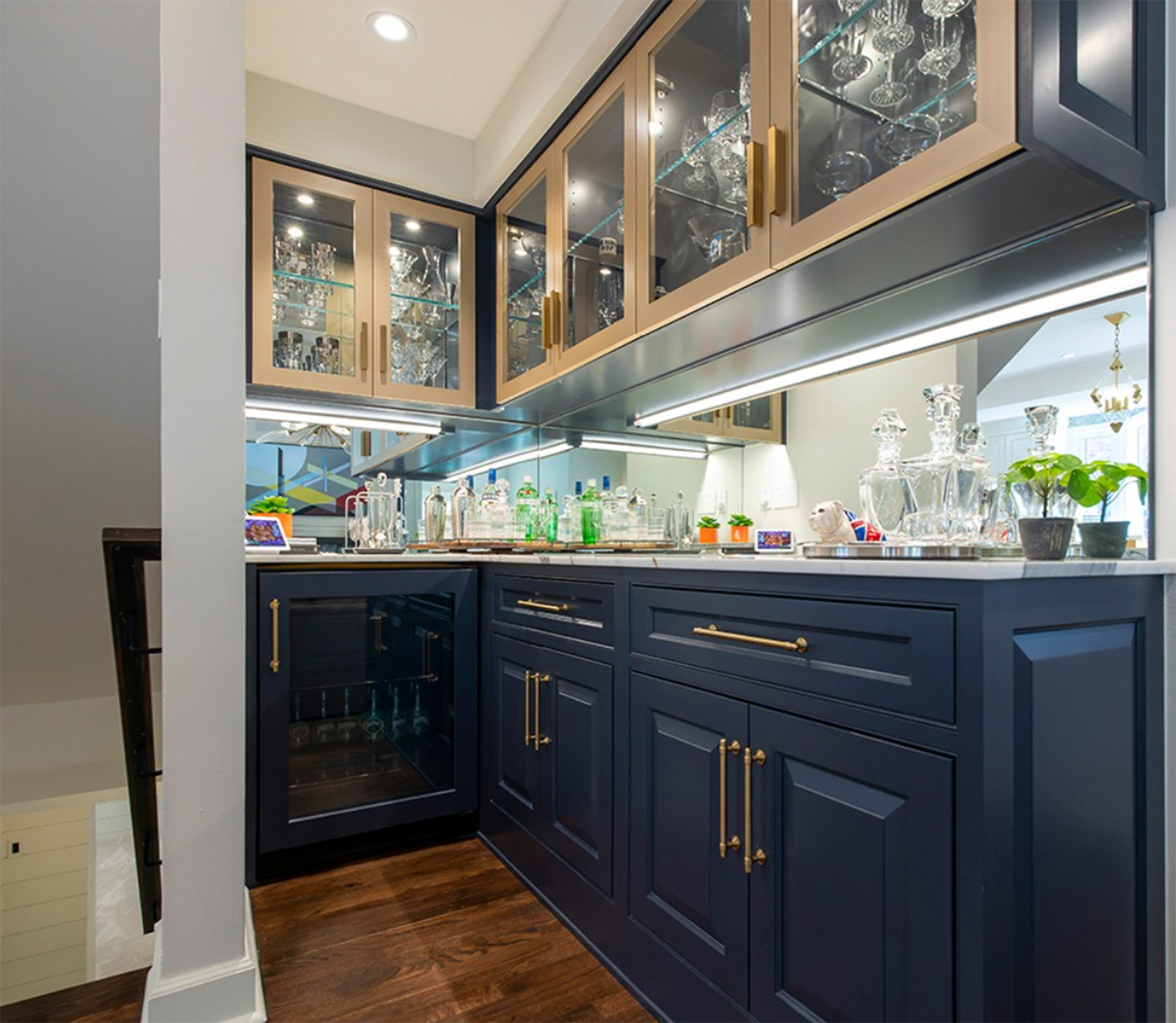 A kitchen with blue cabinets and a wine cooler.